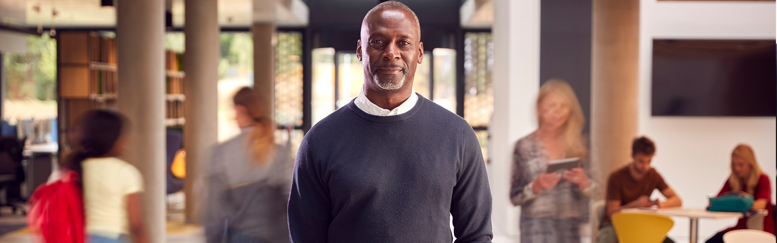 Student in library with blurry people around