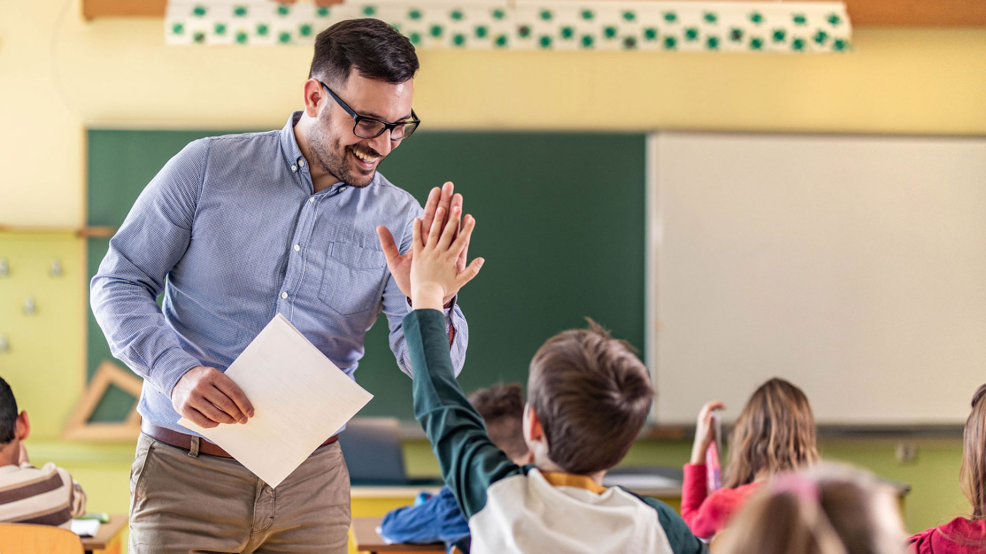 Teacher high-fiving a student