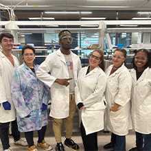 Group of students take a photos in lab gear