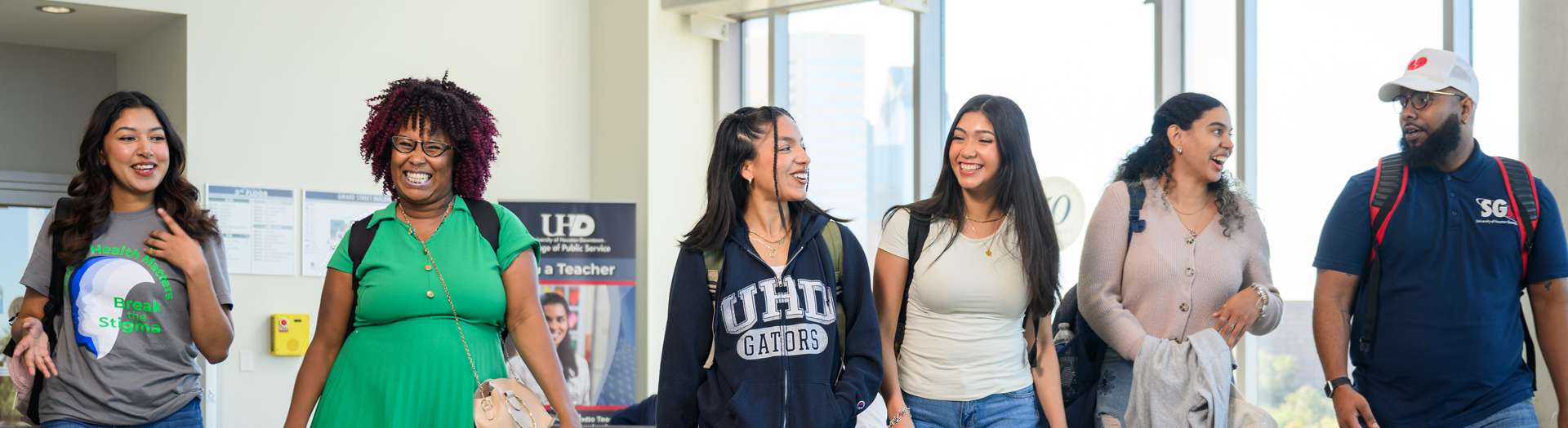 UHD students talking while walking in Hallway