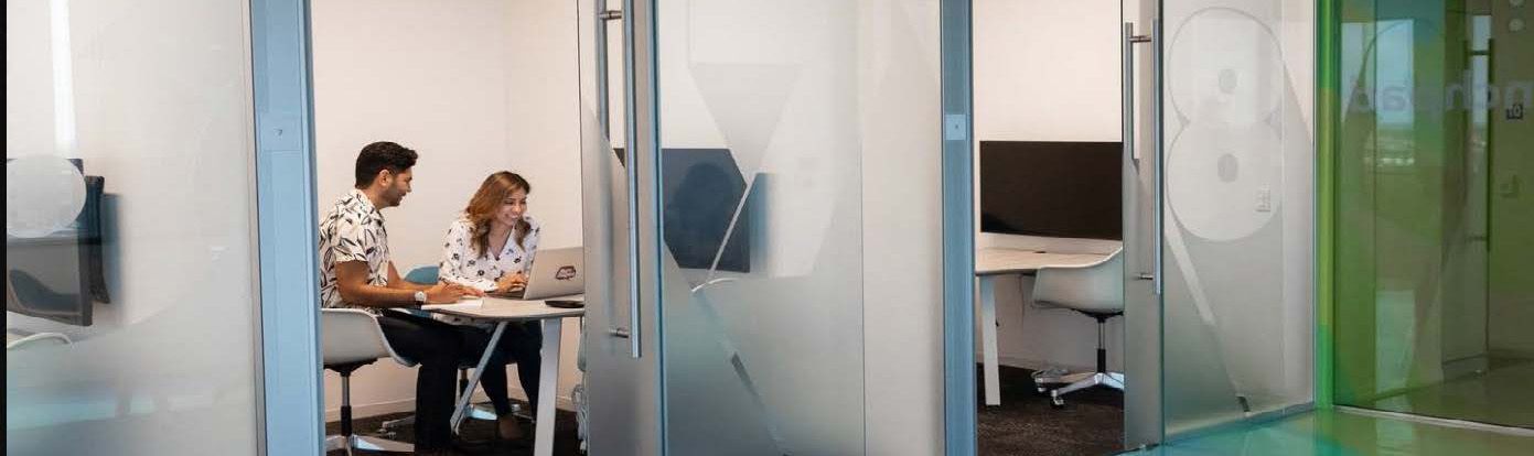 Students inside a glass study room