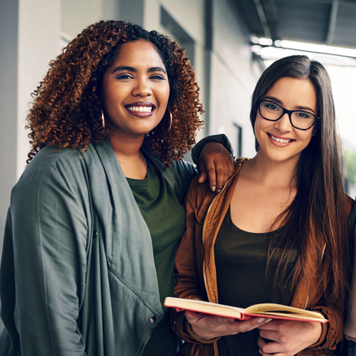 2 female students smiling at the camera