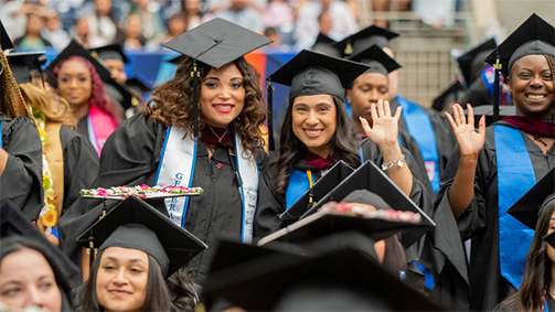 university of houston-downtown graduates wear graduation regalia and wave at the university's 78th commencement ceremonies in spring 2025