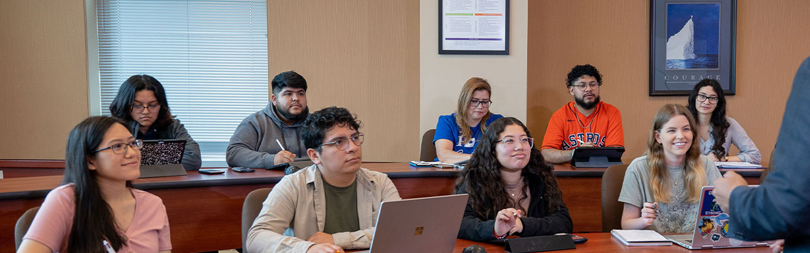 Students listening to professor in classroom