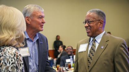 Two donors speak with President Blanchard