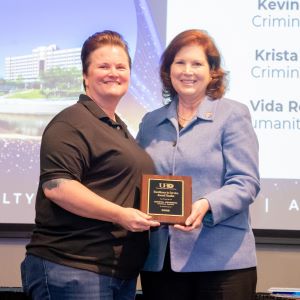 Krista Gehring and Provost Bordelon posing for a photo on stage.