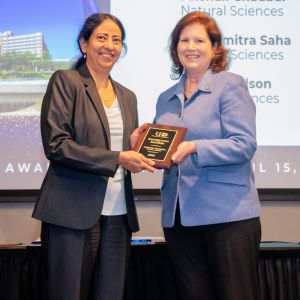 Vaishali Chaubal and Provost Bordelon posing for a photo on stage.