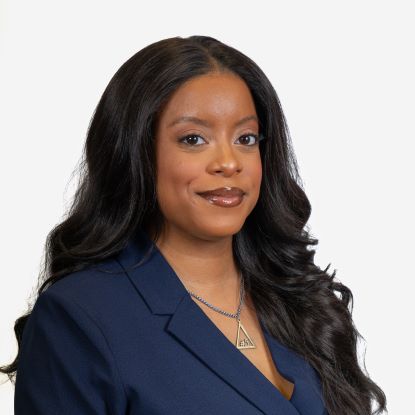 Antoinette Mosley posing for a professional headshot. She is wearing a blue suit.