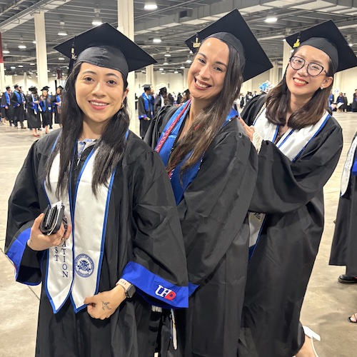 Three graduates prior to the first ceremony.