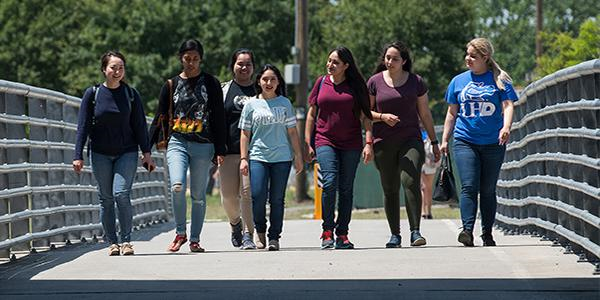 UHD Transfer Students Students walking together across a bridge
