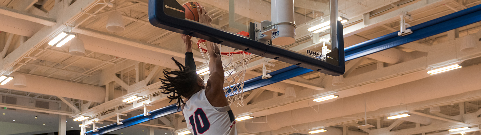 UHD student slam dunking a basketball into thenet