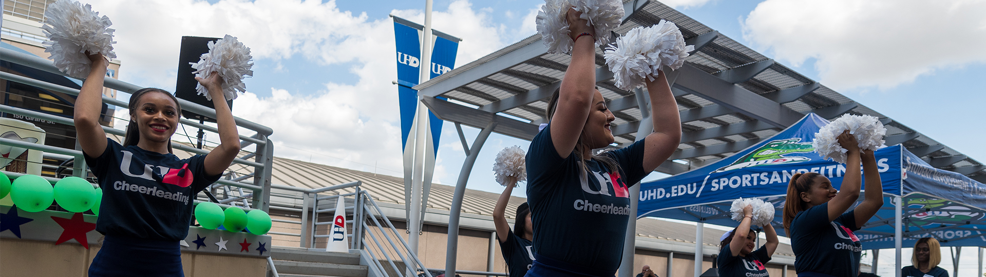UHD cheerleaders with pom poms on the North Deck