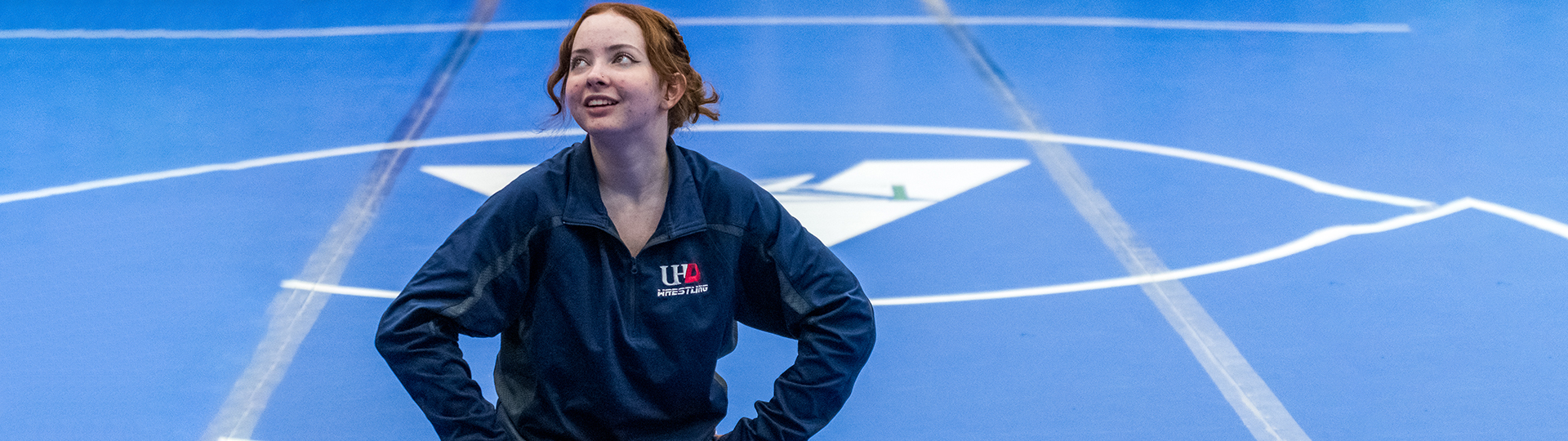 female UHD wrestler stands on the court