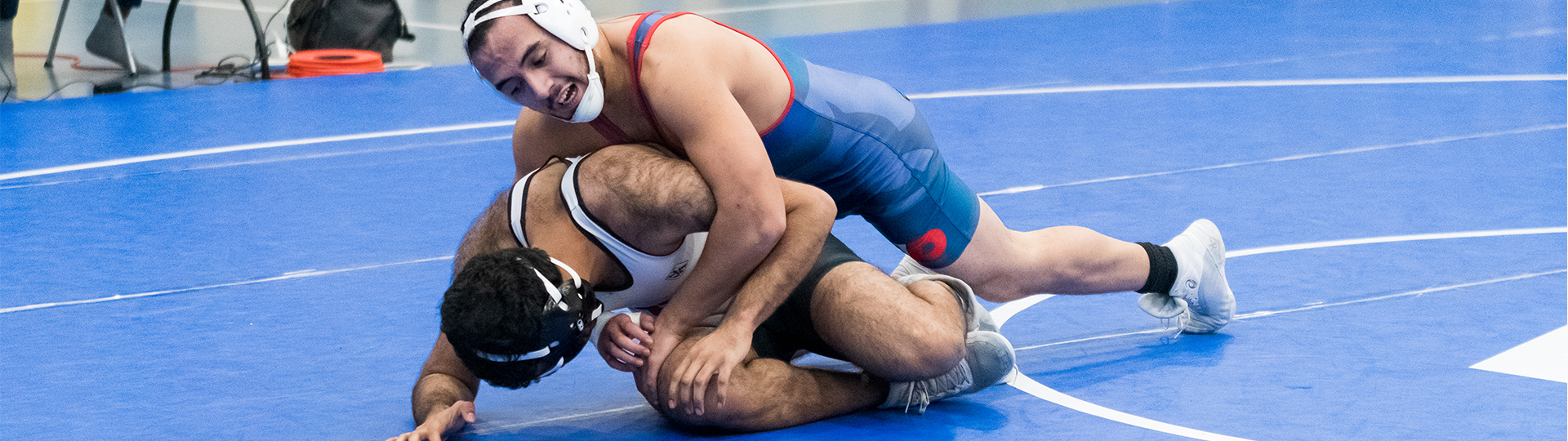 male UHD wrestler competes and pins oppontent