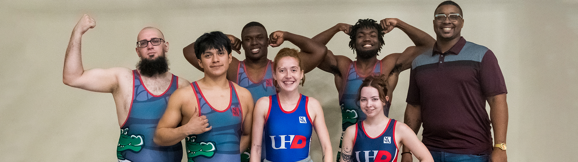 UHD wrestling team with coach