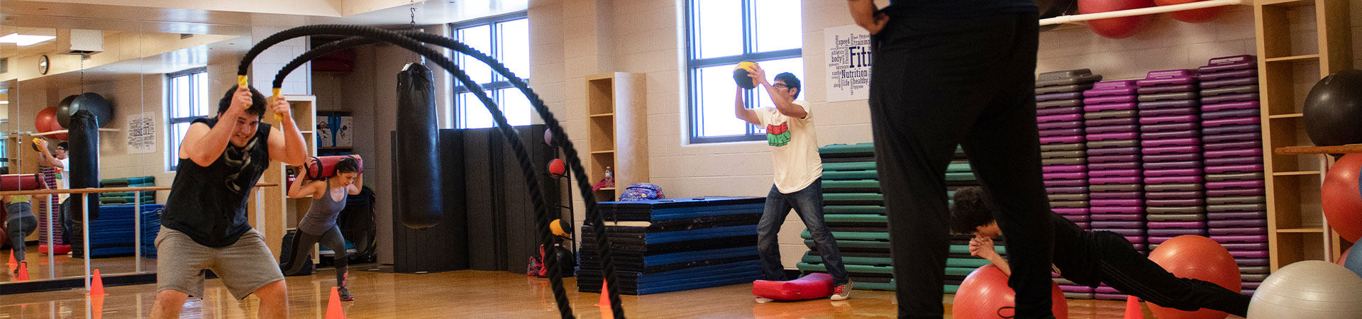 students excecising with free weights in the gym