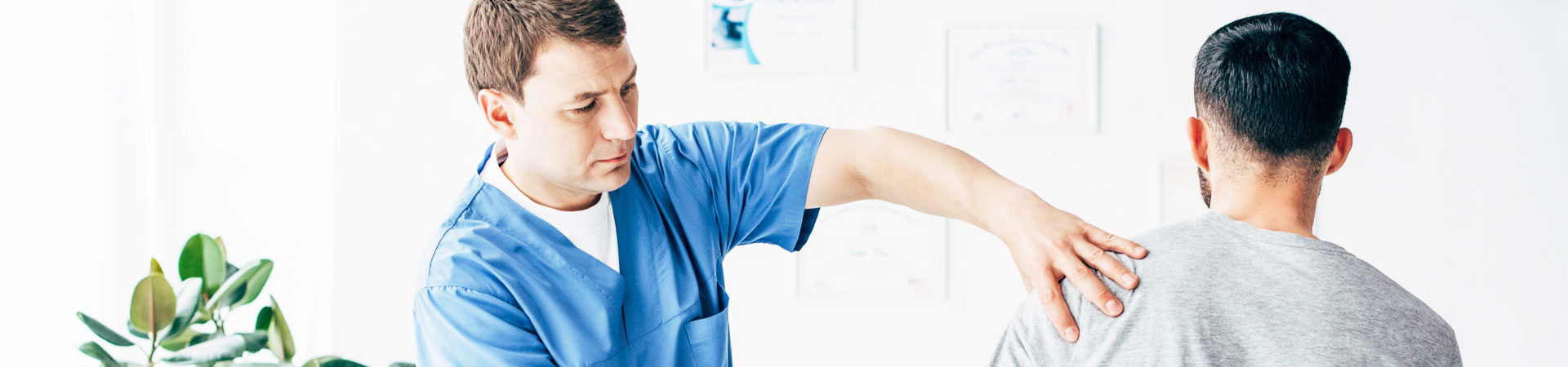 man gives a patient a shoulder massage