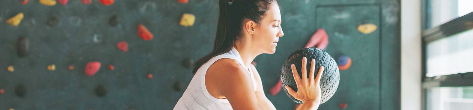 woman excercinsg with medicence ball