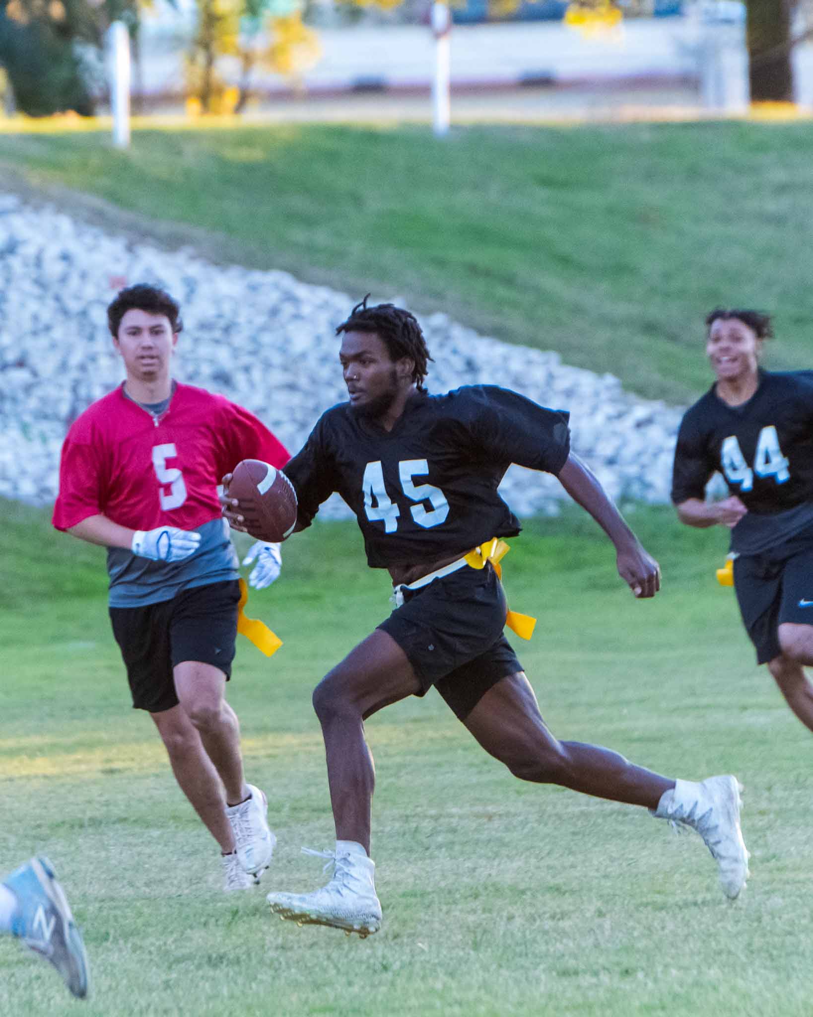 Student running with football 