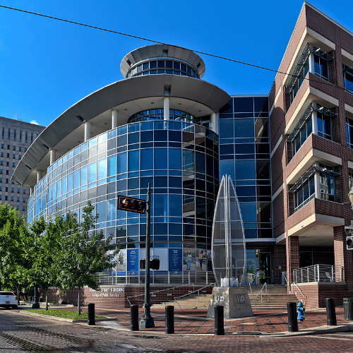 The University of Houston-Downtown College of Public Service building aside the Metro rail in downtown houston.