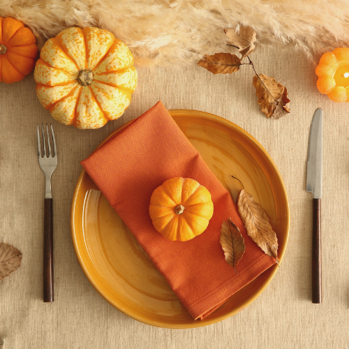 Placesetting decorated with small pumpkins 